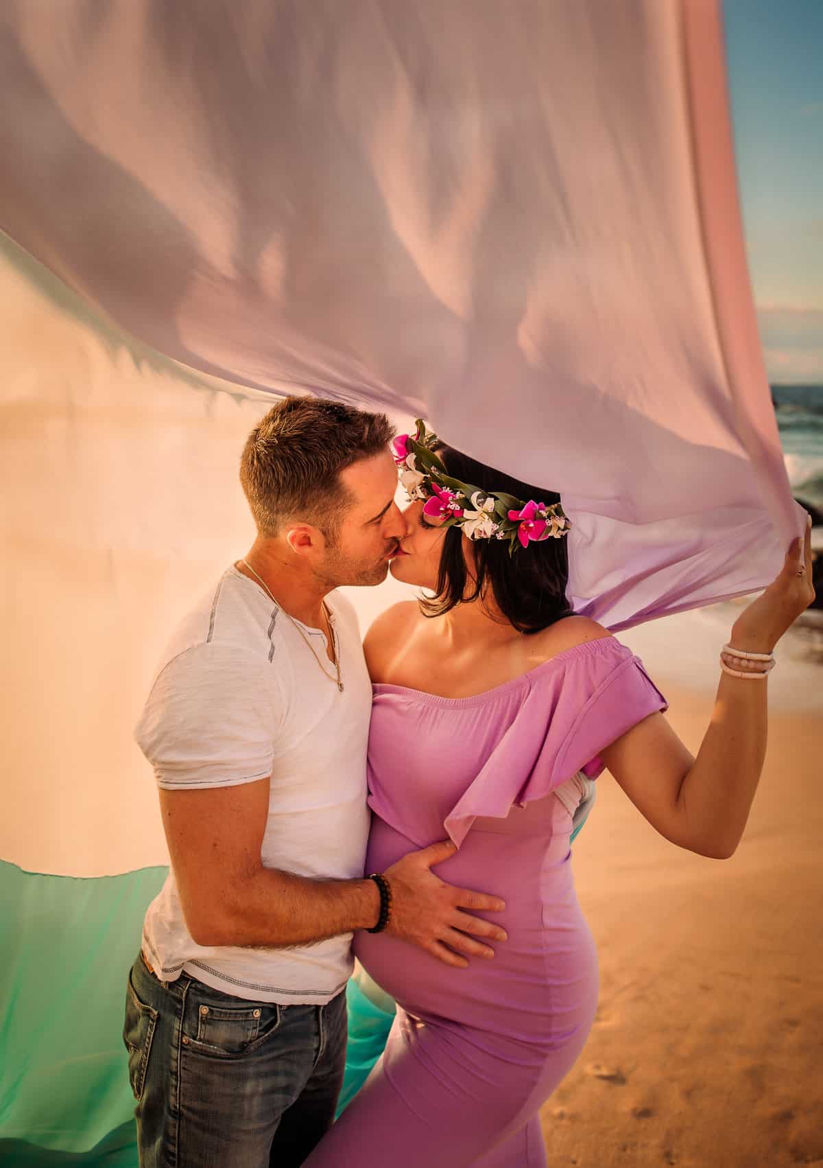 Rachael wears a pink dress and the rainbow skirt.  She kisses her husband as the skirt flows around the tops of the head.