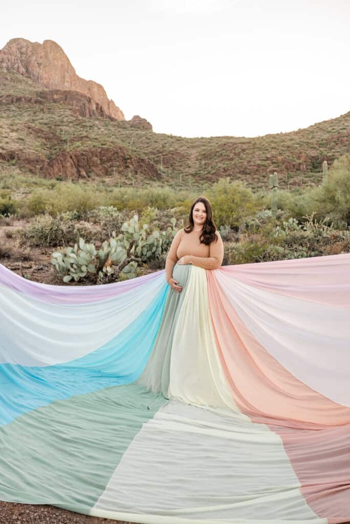 Alex wears the rainbow skirt and it spreads out around her.